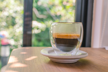 Focus of black coffee on the wood table