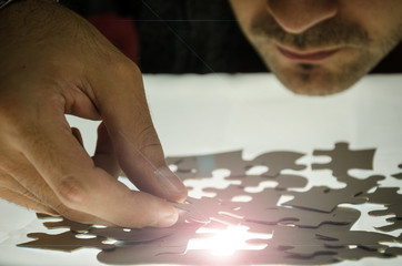 Obraz premium Man puzzle fits on a light surface