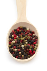 Mixture pepper in wooden spoon on white background