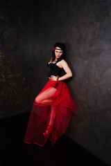 Portrait of woman wearing beautiful long red skirt and corset