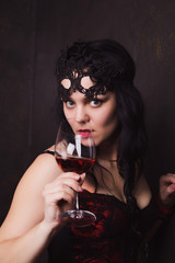 beautiful brunette woman holding a glass of red wine