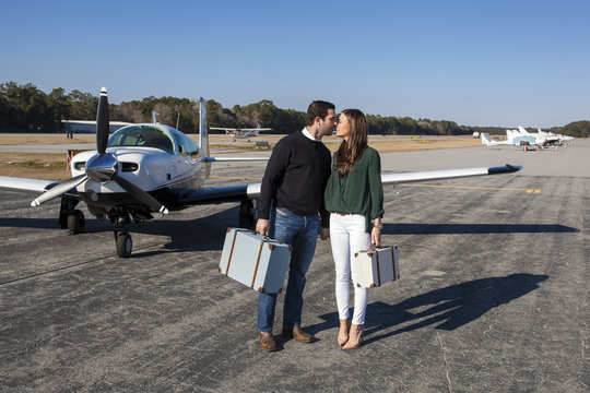 Young couple and private plane
