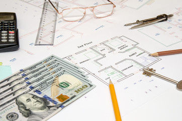 Construction plan, pen, money, model house