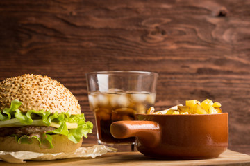 Burger on the brown wooden background