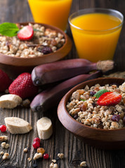 Healthy breakfast of muesli with strawberries, berries, juice an