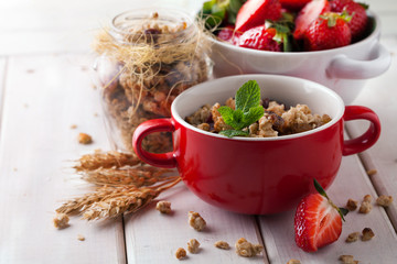 Healthy breakfast of muesli with strawberries, berries, milk and