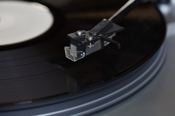 Vinyl player. The rotating disk. Head close-up.