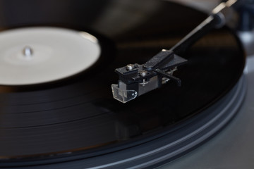 Vinyl player. The rotating disk. Head close-up.