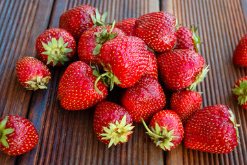 Fresh garden strawberries on old wooden background