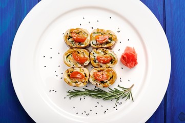 Japan omelette rolls with tomatoes served with ginger, black ses