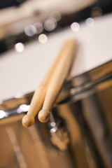 Drum sticks lay on an drum set