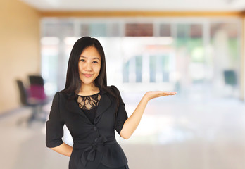 Smiling young Asian business women in black suit with hand prese