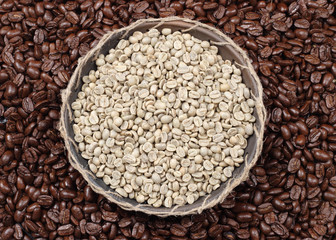 Coffee beans. Unroasted and black roasted coffee beans as background.