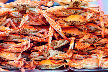 a pile of boiled blue crabs on street market