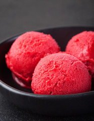 Ice cream cherry, raspberry, strawberry, cranberry , red sorbet Black slate background