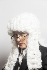 Female judge wearing a wig with eyeglasses  on white