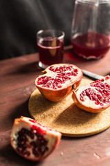 Pomegranate slices and garnet fruit seeds on table
