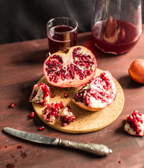 Pomegranate slices and garnet fruit seeds on table