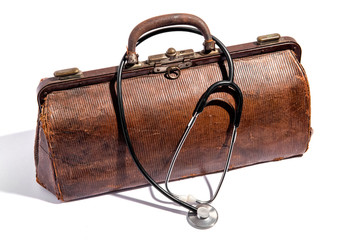 Old battered leather doctors bag and stethoscope