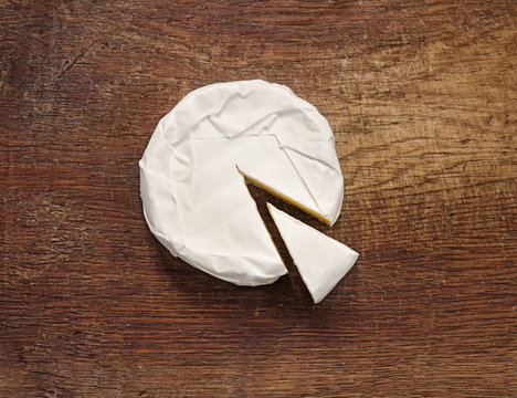 Creamy Brie on rustic wooden background