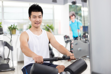 Fototapeta na wymiar young man working out in modern gym