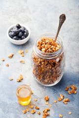Healthy breakfast Fresh granola, muesli with berries in a glass jar on a stone background Copy space