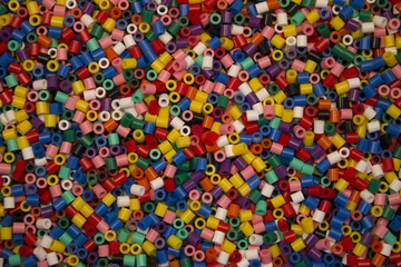 Fototapeta na wymiar multi colored collection of plastic cylinder beads