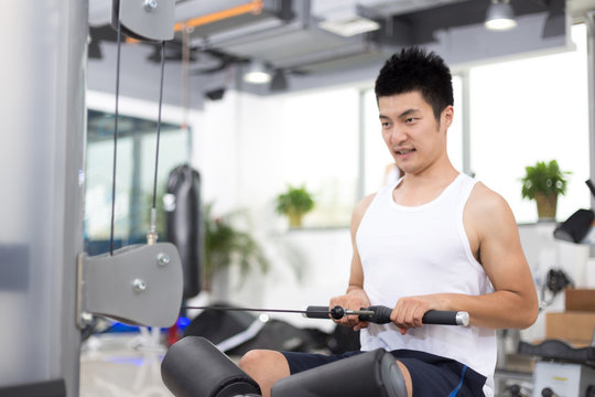 young man working out in modern gym