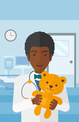 Pediatrician holding teddy bear.