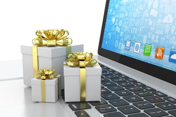 Gift box with ribbon bow on laptop keyboard