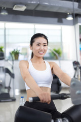 Fototapeta premium beautiful girl working out in modern gym