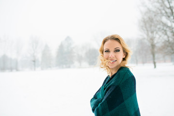 Blond woman throwing her hair outside in winter nature
