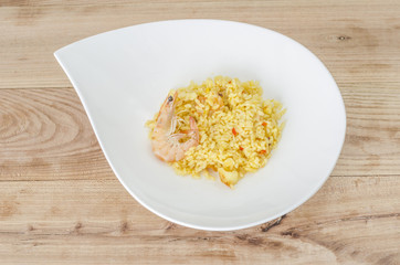 Paella, typical Spanish dish on white background.