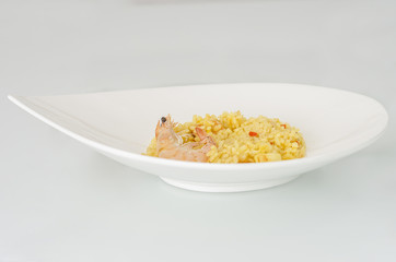 Paella, typical Spanish dish on white background.