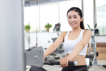 Obraz na płótnie Canvas beautiful girl working out in modern gym