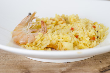 Paella, typical Spanish dish on white background.