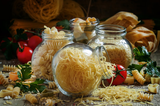 Dry Italian pasta fedelini in a glass jar, assorted mix of diffe