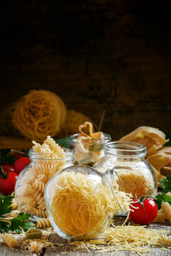 Dry Italian pasta fedelini in a glass jar, assorted mix of diffe