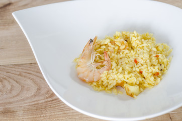 Paella, typical Spanish dish on white background.