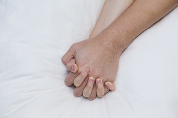 Obraz na płótnie Canvas man hand grabbing woman hand while having sex