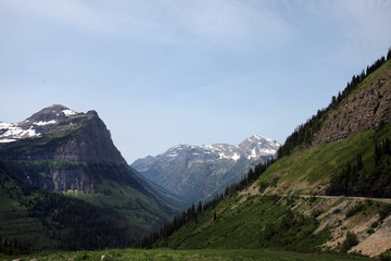 Fototapeta na wymiar The imposing rocky glacial peaks of Glacier National Park in northwest Montana straddle the U.S.-Canadian border, with the Canadian side of the park called Waterton Lakes National Park in Alberta.