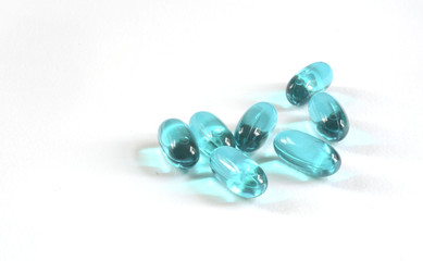 colorful capsules and pills closeup on white