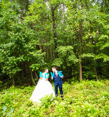 Happy bride and groom holding LOVE letters