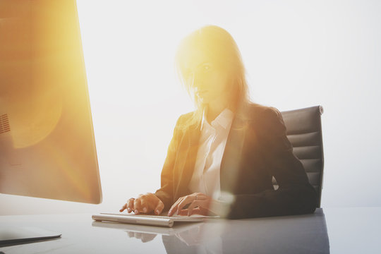 Photo Of Businesswoman Working At Table In White Television Newsroom. White Background