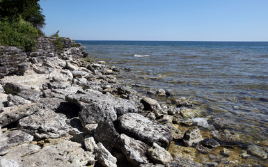 Fototapeta na wymiar Rocky shores define the coastline of Lake Michigan at Cave Point State Park in Door County, Wisconsin.