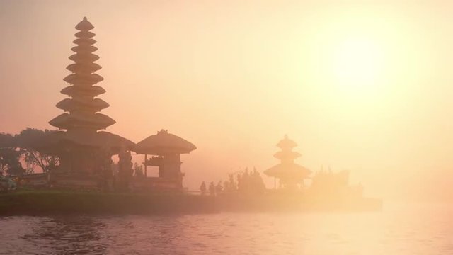Balinese Pura Ulun Danu Bratan at sunset lit with warm yellow sunlight