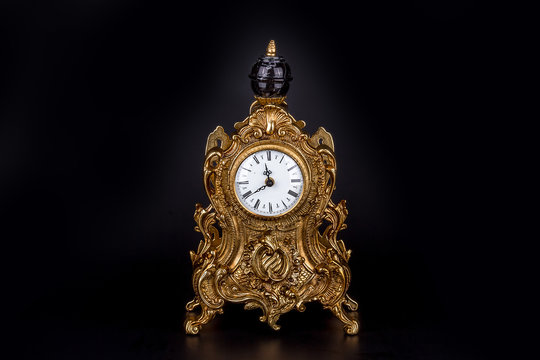 Antique clock on black background