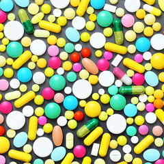 Colorful pills on grey background