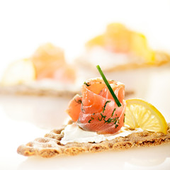 slices of curried salmon  on whole wheat crisps with cream chees