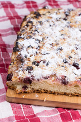 Grandmothers cake with cherries on the wooden board